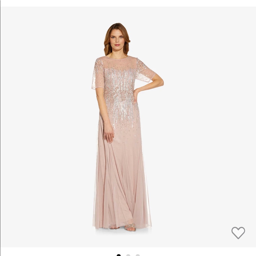 A long gown accented with hand-beaded florals round neckline chic short sleeves.